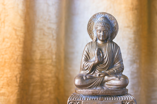 Chinese buddha sculpture on an yellow background