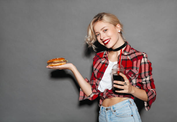 istock Cheerful young girl posing with fast food 698653016