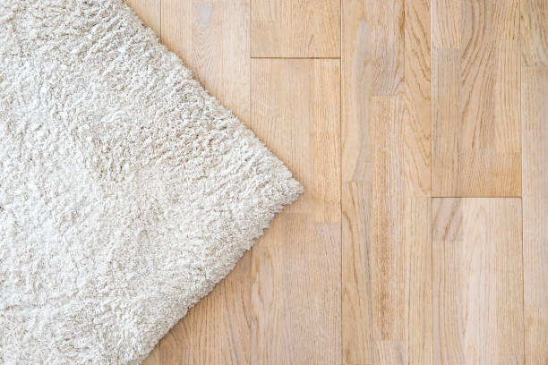 istock Wooden laminate floor and soft carpet 698654482