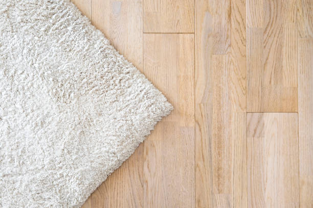Wooden laminate floor and soft carpet stock photo