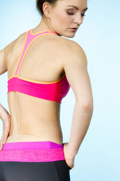istock Woman with medical kinesio taping on back 698655688