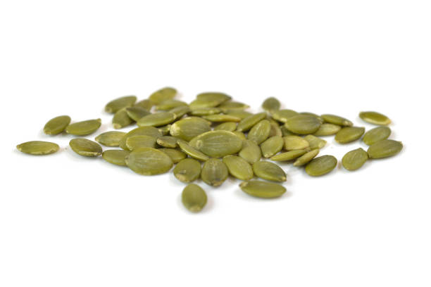 istock Pumpkin seeds on white background - isolated 698669226