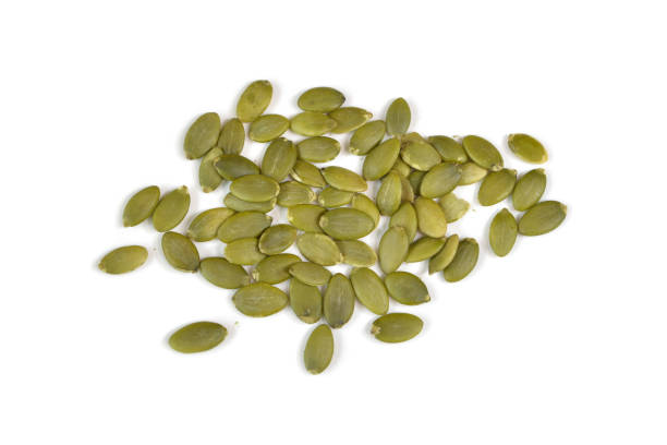 istock Pumpkin seeds on white background - isolated 698669290