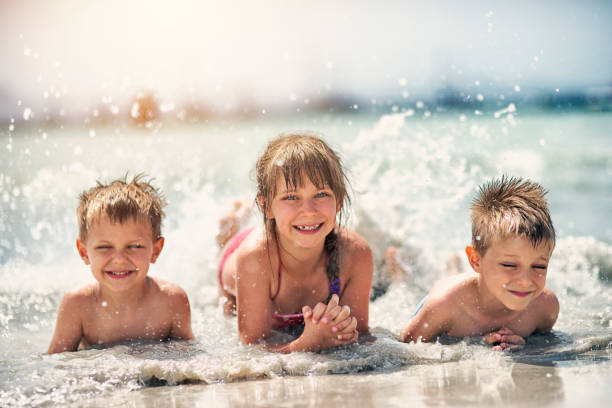 istock Kids splashing in the mediterranean sea 698672272