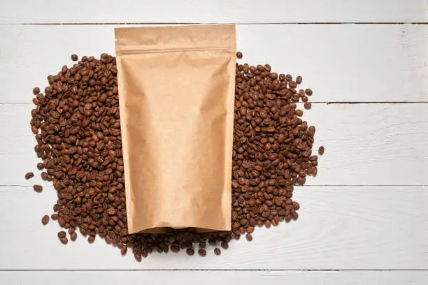 Photo of Mock-up craft paper pouch bags with coffee beans