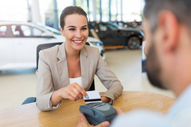 istock Woman buying a new car 698673230