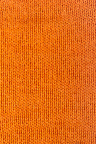 istock Sweater or scarf fabric texture large knitting. Knitted jersey background with a relief pattern. Wool hand- machine, handmade, orange 698676808