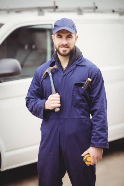 istock Repairman holding a hammer 698683776