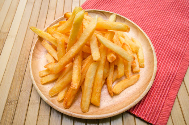 istock French fries on wood plate 698684170