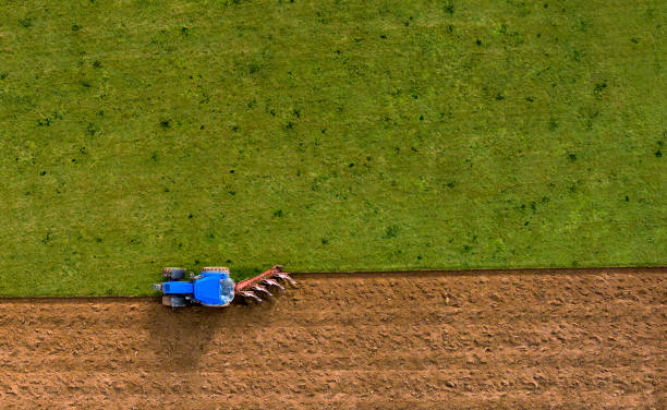istock Tractor Ploughing Plowing Field - Aerial Shoot 698684854
