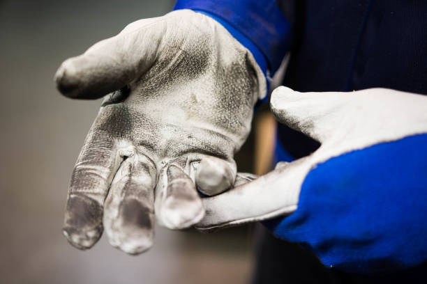 Man wearing a pair of protection gloves. stock photo
