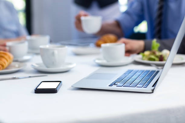 istock Laptop and mobile phone on the restaurant table 698690282