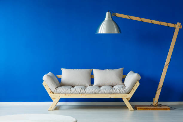 istock Wooden couch in blue room 698690526