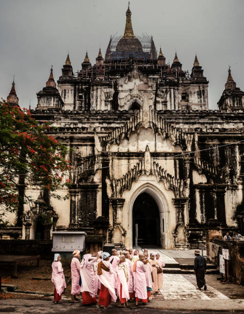 Group of buddhist nuns at the That Bin Nyu temple Bagan Myanmar. Although the majority of monks in Myanmar are males there are also some women that also follow this path of worshipping Buddha. This temple build in the XII century is one of the largest in Bagan