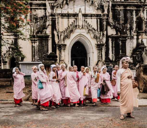 Group of buddhist nuns at the That Bin Nyu temple Bagan Myanmar. Although the majority of monks in Myanmar are males there are also some women that also follow this path of worshipping Buddha. This temple build in the XII century is one of the largest in Bagan