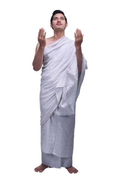 Young asian muslim man with ihram praying