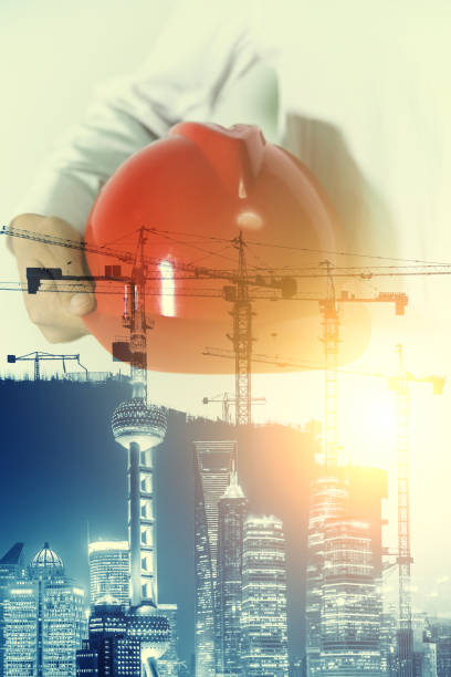 istock Multiple Exposure of man holding a safety helmet 698709346