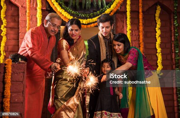 Indian Family Celebrating Diwali Festival With Fire Crackers Stock Photo - Download Image Now