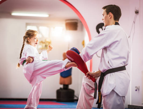 istock Cute preschool girl on taekwondo training 698711604