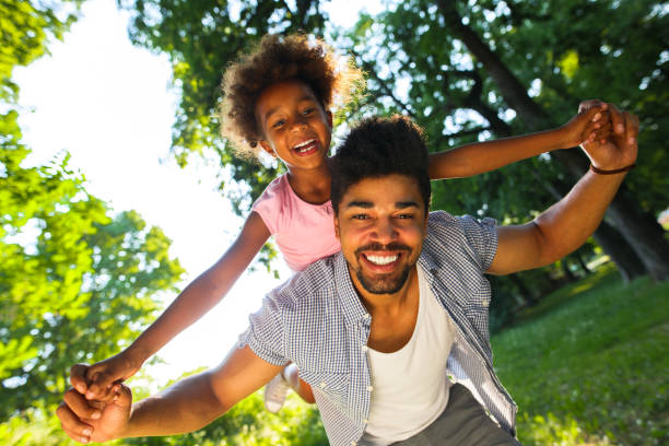 istock Smiling father giving his daughter piggyback ride. 698714298