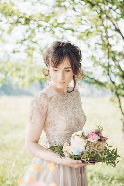 istock bride holding wedding cake. wedding cake decorated with flowers 698723692