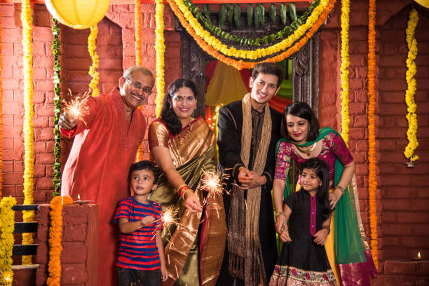 Indian Family celebrating Diwali festival with fire crackers Indian Family celebrating Diwali festival with fire crackers south photos stock pictures, royalty-free photos & images