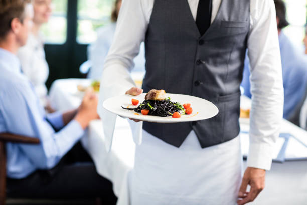 istock Waiter holding a plate of meal 698726260