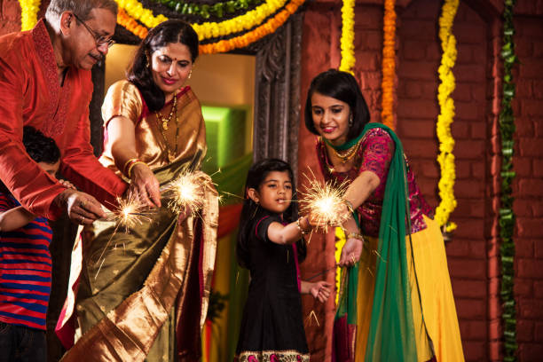 istock Indian Family celebrating Diwali festival with fire crackers 698726310