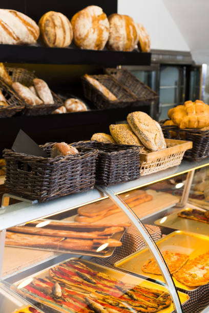 istock Modern bakery with different kinds of bread, cakes and buns 698732710