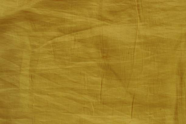 istock Yellow wrinkled fabric texture for background 698733934