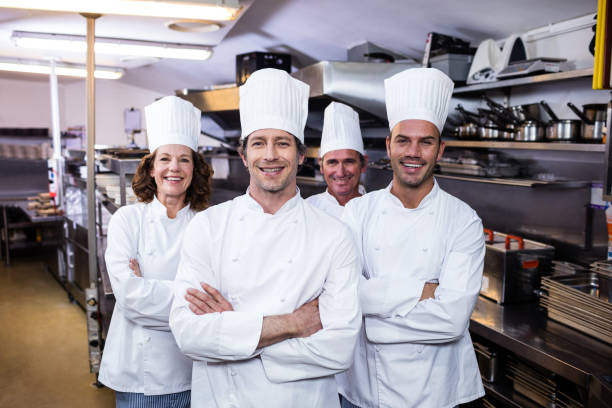 istock Group of happy chefs smiling at the camera 698734102