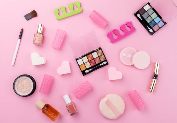 istock Beauty Spa Feminine Concept. Different Make Up Beauty Care Essentials Cosmetics on Flat Lay Pink Background. Top View. 698745892