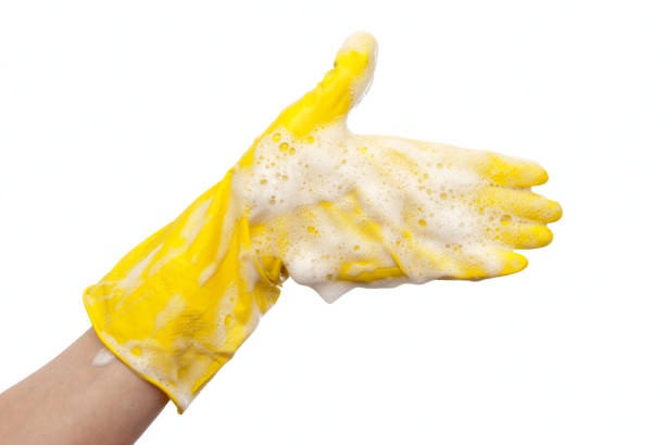 istock Hand in yellow rubber glove 698748136