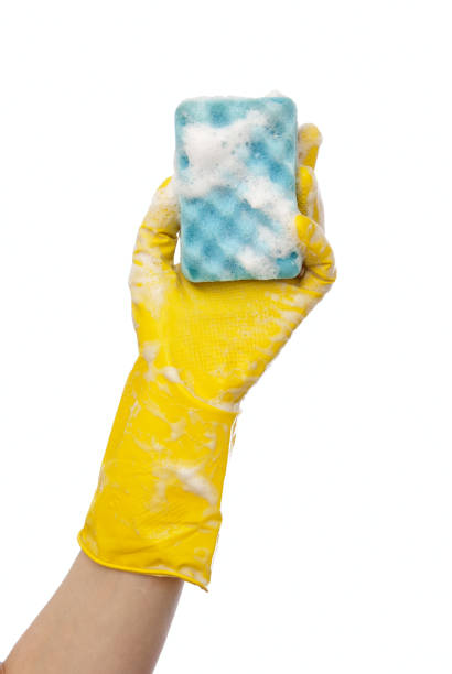istock Hand in yellow rubber glove 698751080
