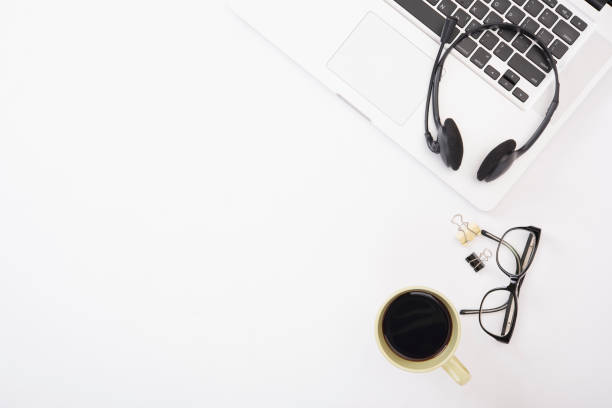 istock Modern Office desk with computer, headset and coffee.Top View table from above with copy space for input the text. 698757940