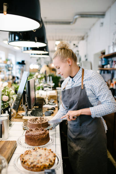 istock Home Bakery Girl Cutting Open a Cake 698758040
