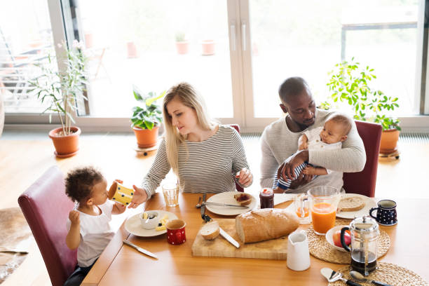 istock Young interracial family with little children having breakfast. 698764500