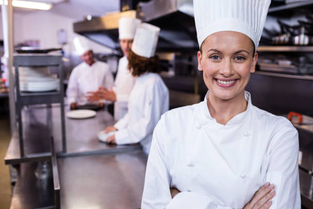 istock Happy chef standing in commercial kitchen in a restaurant 698765190