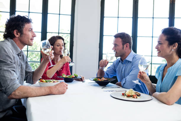istock Group of friends having wine in a restaurant 698765262