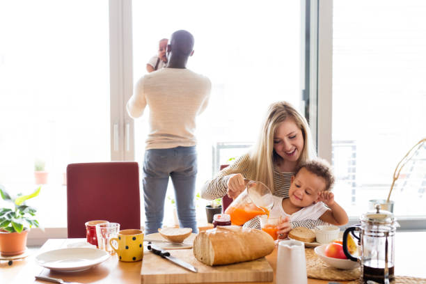 istock Young interracial family with little children having breakfast. 698765376