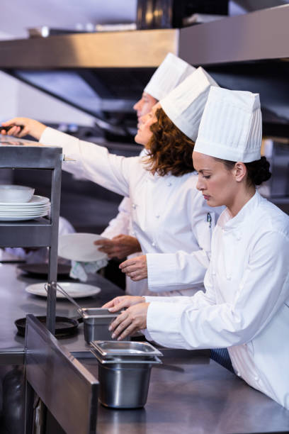 istock Two chefs working at order station in a kitchen 698771182