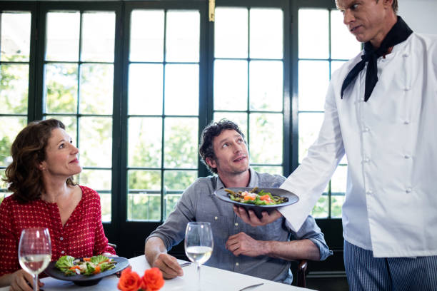 istock Chef serving meal to a couple 698771338