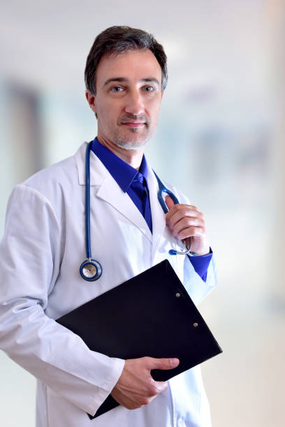 istock Caucasian general doctor with black clipboard half body vertical 698771574