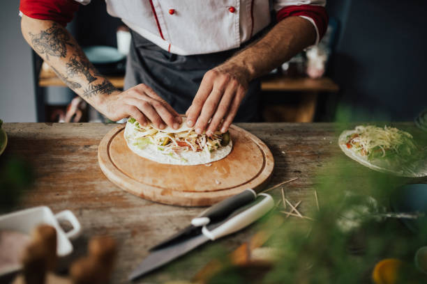 Tattooed chef has to roll up the tortilla before frying it
