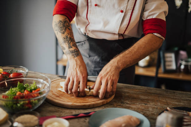istock Tattooed chef prepares meal at home 698773852