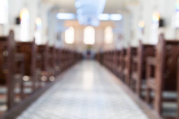 istock Defocused interior of Catholic church with pews 698778616