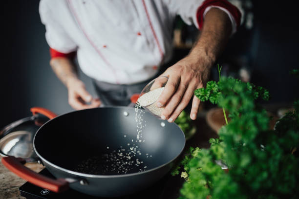 istock The chef is pouring sesame into hot pan 698780180