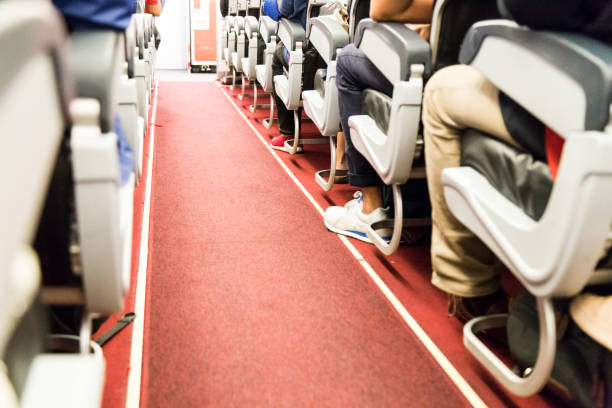 istock Floor proximity reflector line aids airplane evacuation under dark conditions. 698780224