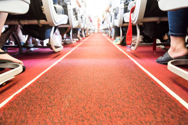 istock Floor proximity reflector line aids airplane evacuation under dark conditions. 698780398