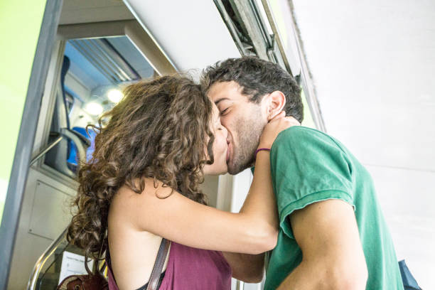 istock Young couple kissing at the train station 698781164